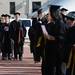 Masters level and PHD students file past the Burton Memorial Tower as they walk over to Hill Auditorium for commencement on Friday morning. Melanie Maxwell I AnnArbor.com